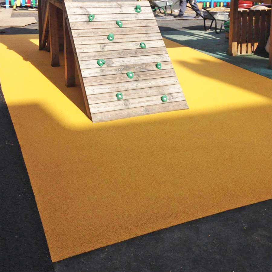 Rubber crumb surfacing with colours and shapes in a play area