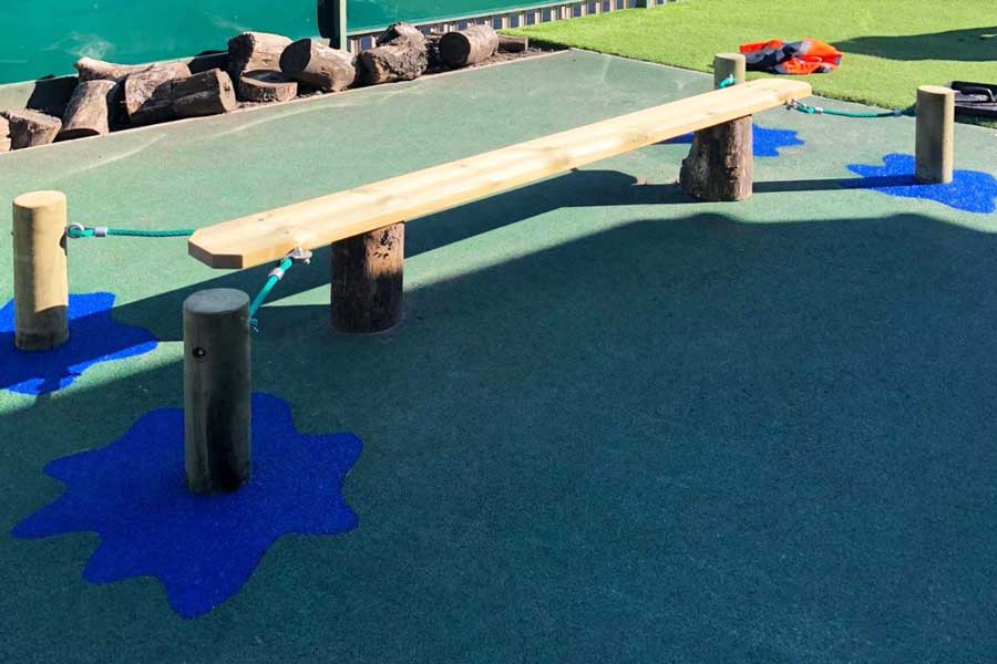 Rubber crumb surfacing with colours and shapes in a play area